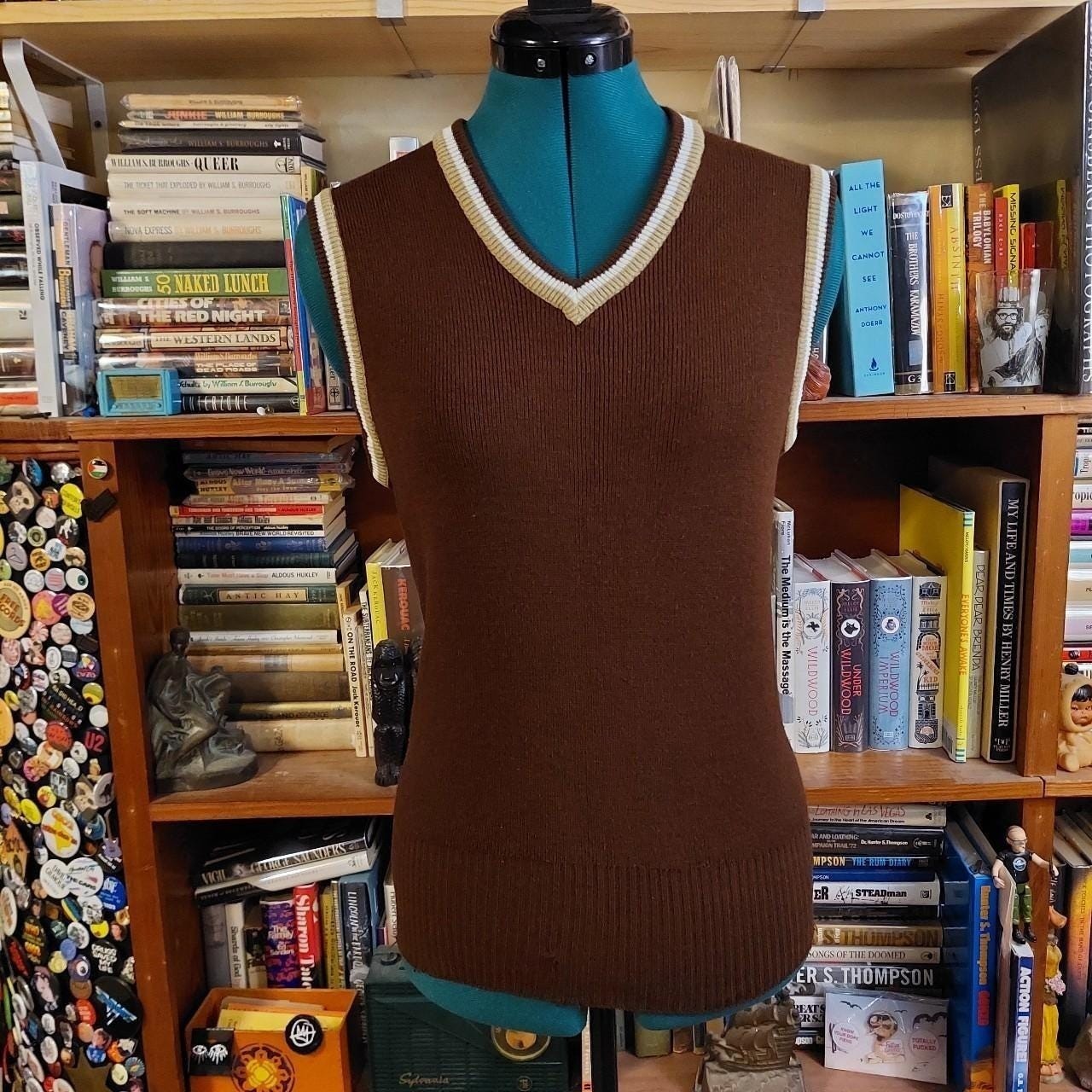 Vintage brown V-neck sweater vest with tan and white details.