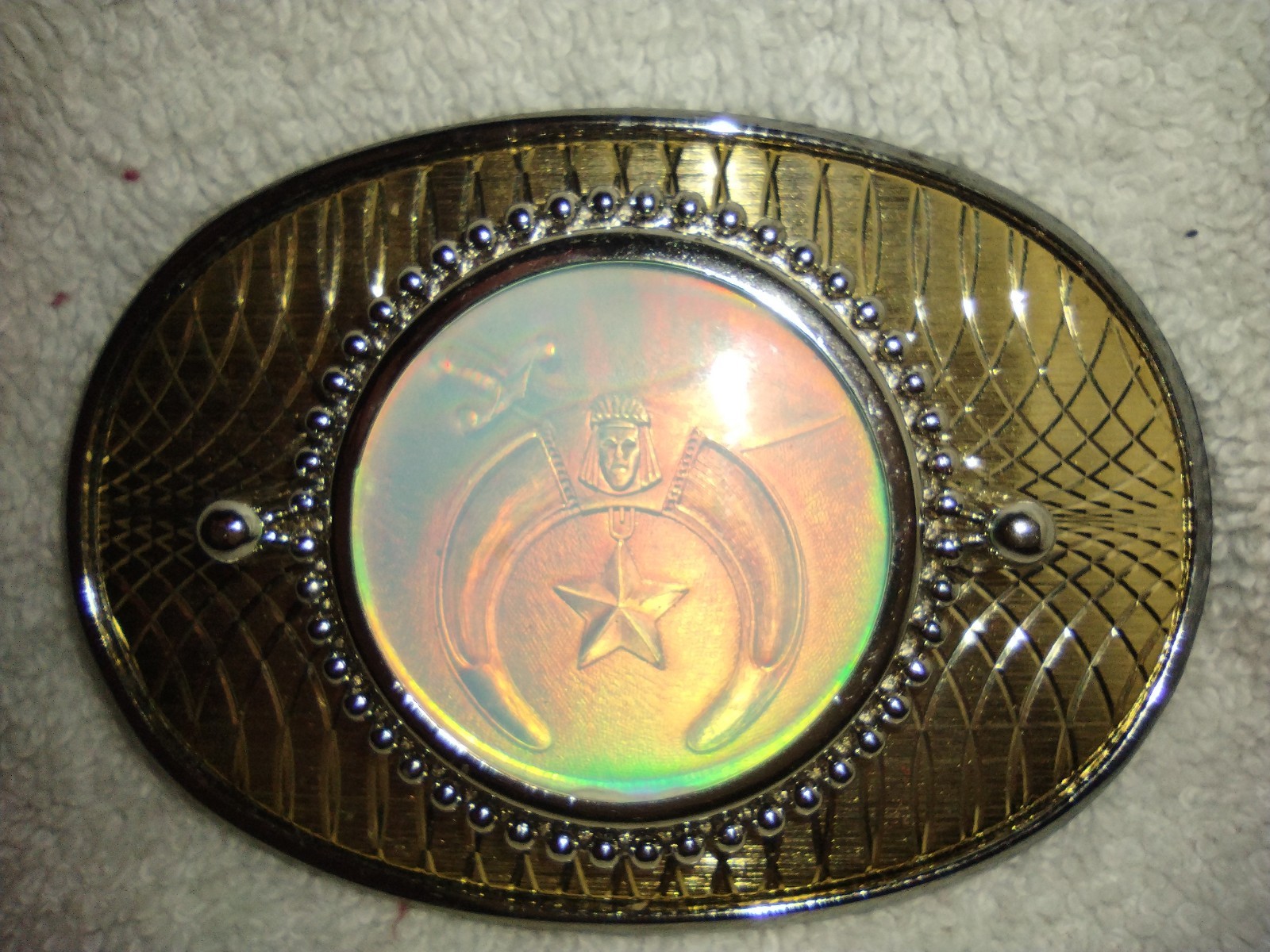 Shiny gold tone belt buckle with Shriners/Mason holographic inset picture