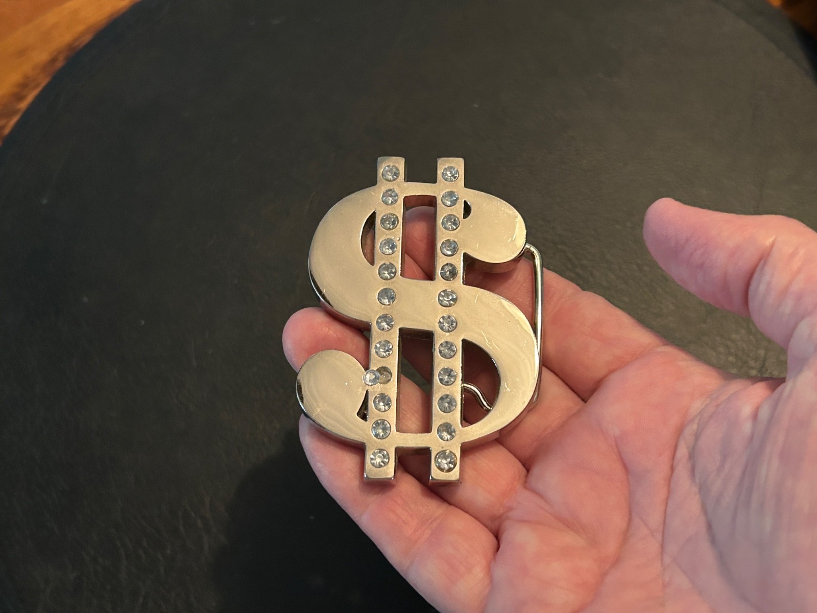 Thick silver chrome dollar sign belt buckle, two rows of rhinestones